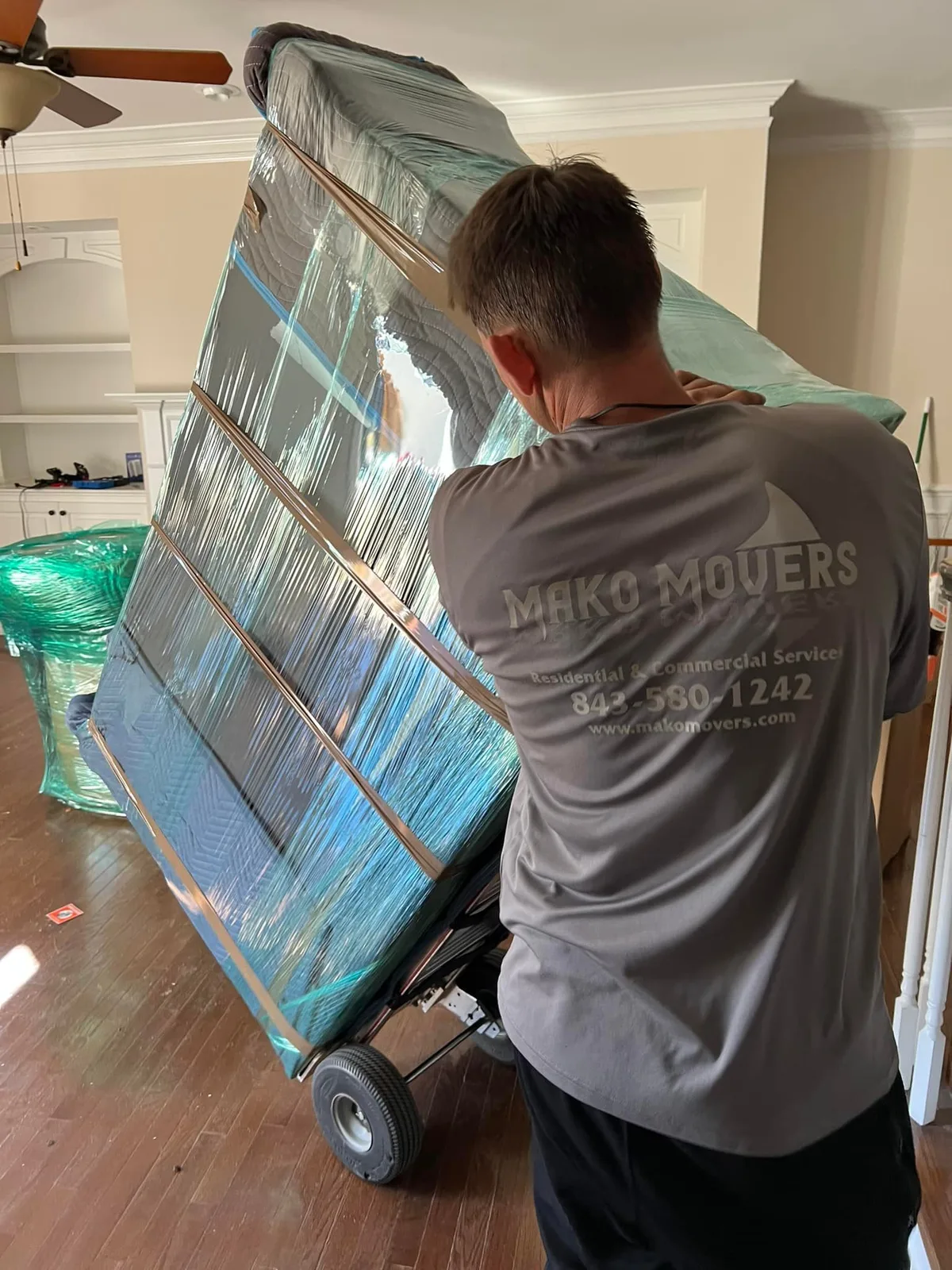 Mako Movers residential moving crew protecting furniture inside a Charleston home